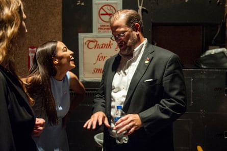Alexandria Ocasio-Cortez laughs backstage with congressional candidate James Thompson.