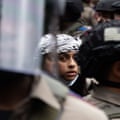 Young person in keffiyeh surrounded by officers in riot gear