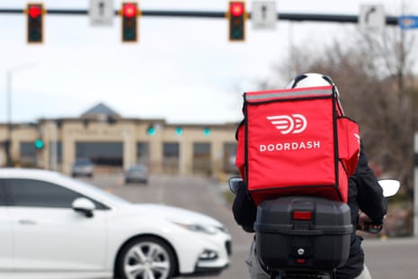 A food delivery rider waits at a traffic light on 30 March 2020 in Lone Tree, Colorado