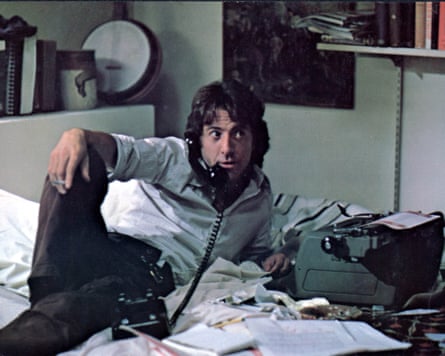 man lying on bed using telephone