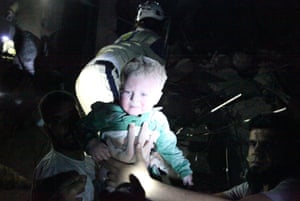 The Syrian civil defence rescue a baby from rubble after a regime airstrike