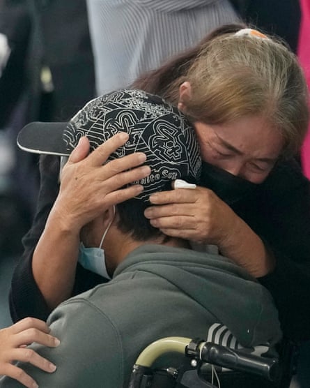 A woman hugs a man who has returned to Thailand from Israel