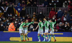 Juanmi of Real Betis celebrates with teammates after scoring the opening goal of the game.