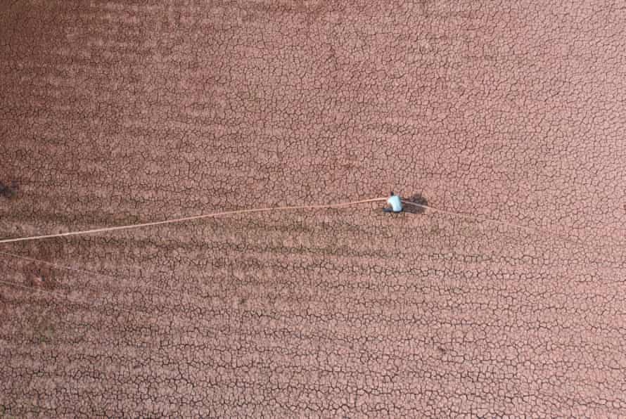 A farmer irrigates a parched field in Sichuan, China