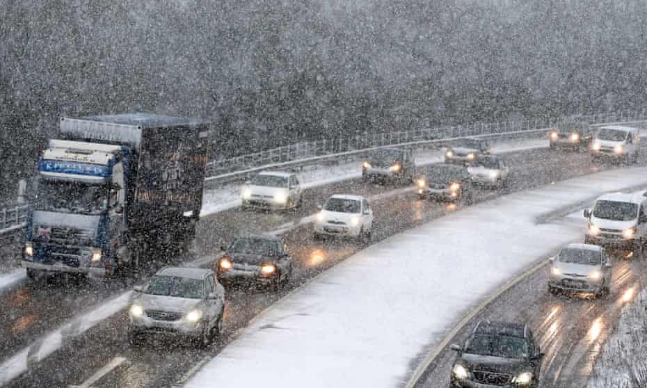 Cars make their way through the snow on the A1 northbound in Gateshead, Tyne and Wear