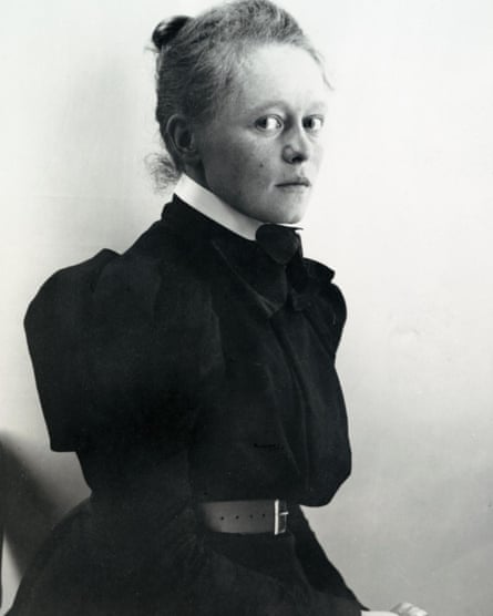 Black and white image of blonde woman, her hair tied back, looking perhaps apprehensively at viewer