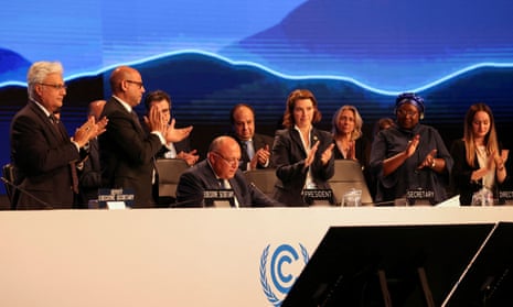 Delegates applaud as Cop27 president Sameh Shoukry delivers a statement during the closing plenary at the  climate summit in Red Sea resort of Sharm el-Sheikh