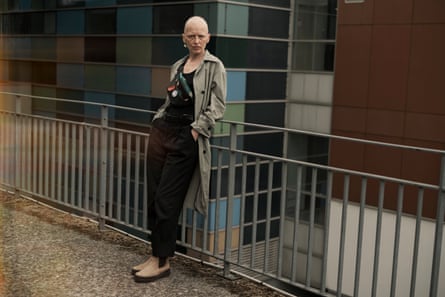 Breteau leans on a railing near a hospital.