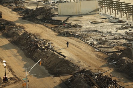 aerial image of a cyclist passing piles of dirt and debris