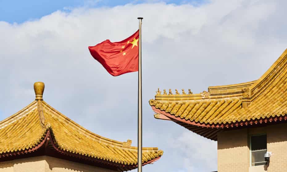 A Chinese national flag flies outside the Chinese embassy in Canberra