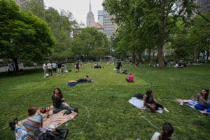 People are seen practicing social distancing in white circles at the Madison Square park, New York City, on Friday.