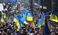 Demonstrators waving Ukrainian national flags during a protest march in central London in March 2022.