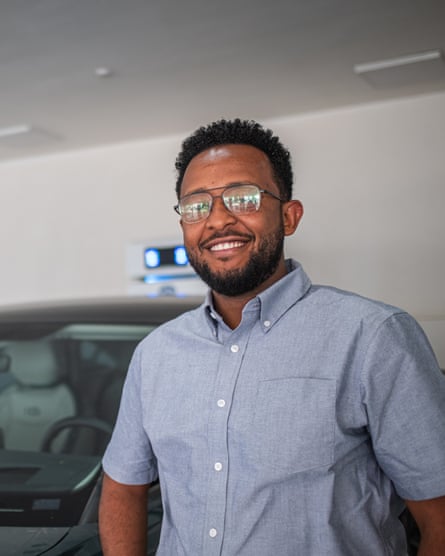 A smiling man in glasses and casual shirt
