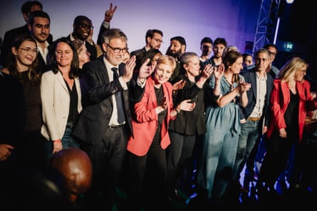 A group of politicians applaud at a gathering