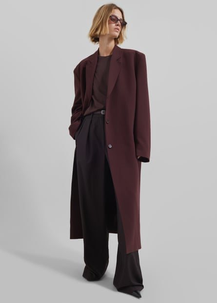 model wearing Burgundy coat, top and trousers