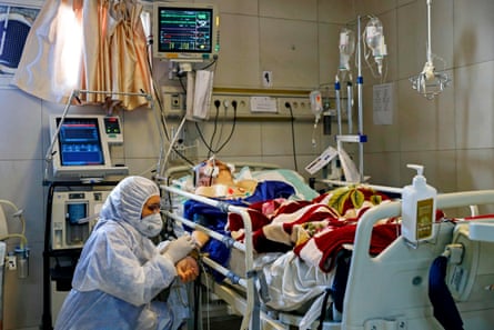 An Iranian medic treats a patient infected with the Covid-19 virus at a hospital in Tehran.