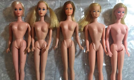 five naked barbie dolls