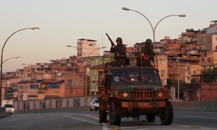 Soldiers patrol near the Maré favela on 24 July 2016, as a massive security operation that is expected to last through the Olympics begins.