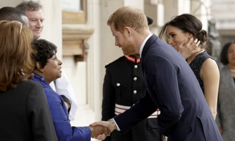 Prince Harry and his Meghan Markle are greeted by Doreen Lawrence, Stephen’s mother, as they arrive to attend the service at St Martin-in-the-Fields church in London.