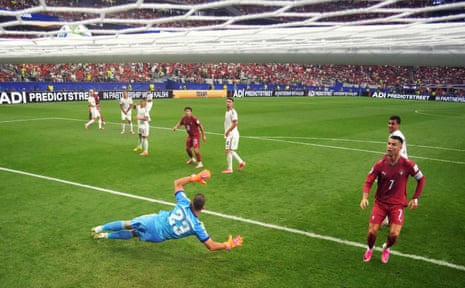 Portugal’s Nuno Mendes shoots at goal and hits the crossbar.