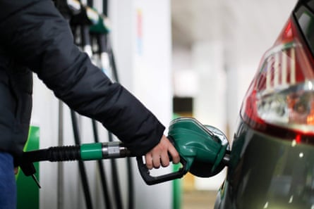 Man filling up his car at a petrol station