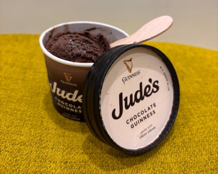 A tub of chocolate Guinness cake ice-cream with a wooden spoon inside