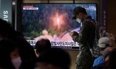 A South Korean soldier walks past a TV broadcasting a news report on North Korea firing a ballistic missile towards the sea off its east coast.