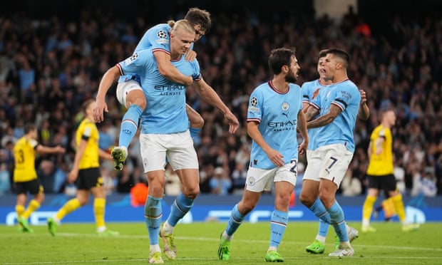 John Stones leaps on to Erling Haaland’s back after the Norwiegan’s winner for Manchester City