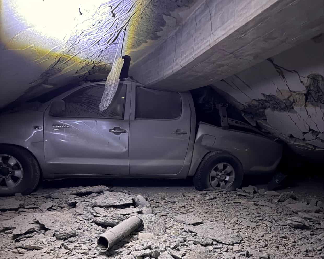A car under the rubble of a building in the aftermath of earthquakes, in Caraballeda, La Guaira state.