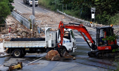 Workers clear boulders and rocks after a landslide in Wollongong.