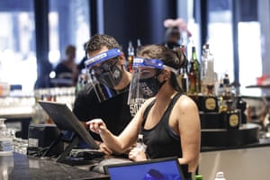 Bartenders wearing masks and face shields at Slater’s 50|50 in Santa Clarita, California, yesterday