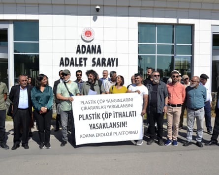Protesters gather outside the Adana building.