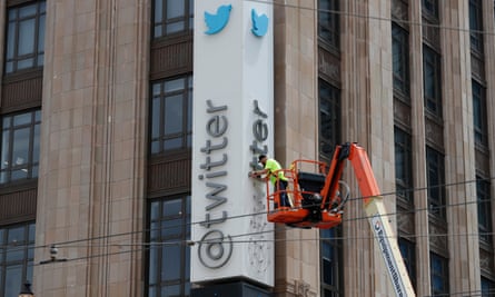 Workers remove letters from the Twitter sign at the company’s San Francisco headquarters amid rebranding.