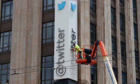 Workers remove letters from the Twitter sign in San Francisco