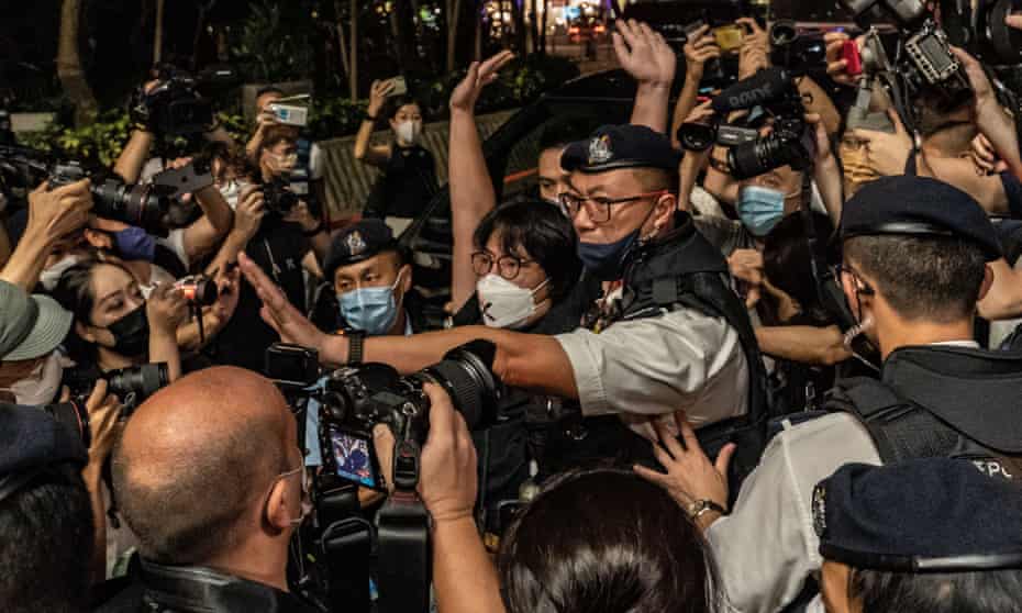 Police officers detain a pro-democracy activist outside Victoria Park, the traditional site of the annual Tiananmen candlelight vigil.