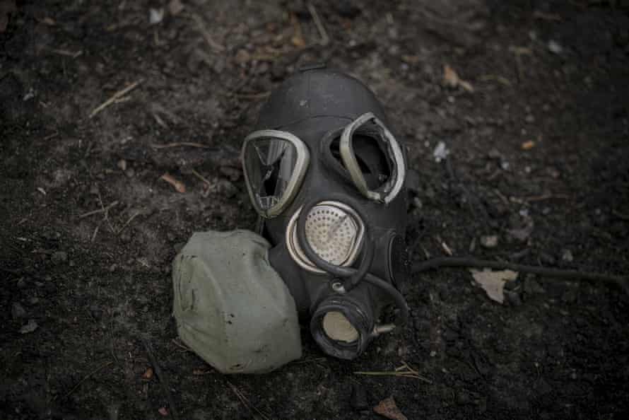 A damaged gas mask lies on the pavement outside Kyiv, Ukraine.