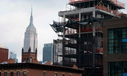 A building under construction is seen in front of the Empire State Building in New York.