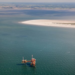 NAM gas drilling rig near mud flats in the Wadden Sea Islands.