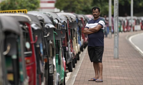 An autorickshaw driver waits in a queue hoping to get fuel in Colombo