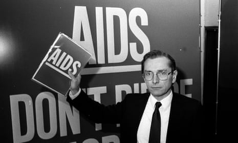 Norman Fowler, who features in Positive, pictured in London in 1986, in front of a poster reading Aids - Don't Die Of Ignorance.