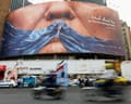 People driving past an anti-US billboard in Tehran.
