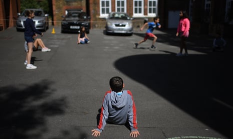 Year 6 children playing outside while observing social distancing at a school in north London.