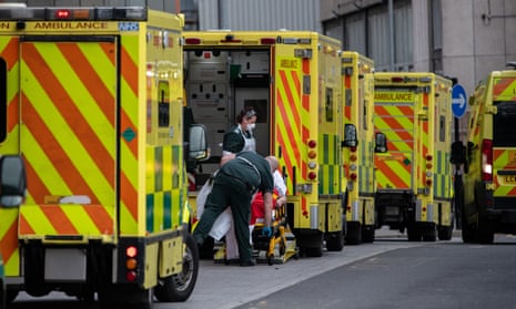Paramedics take a patient from an ambulance into the Royal London Hospital 