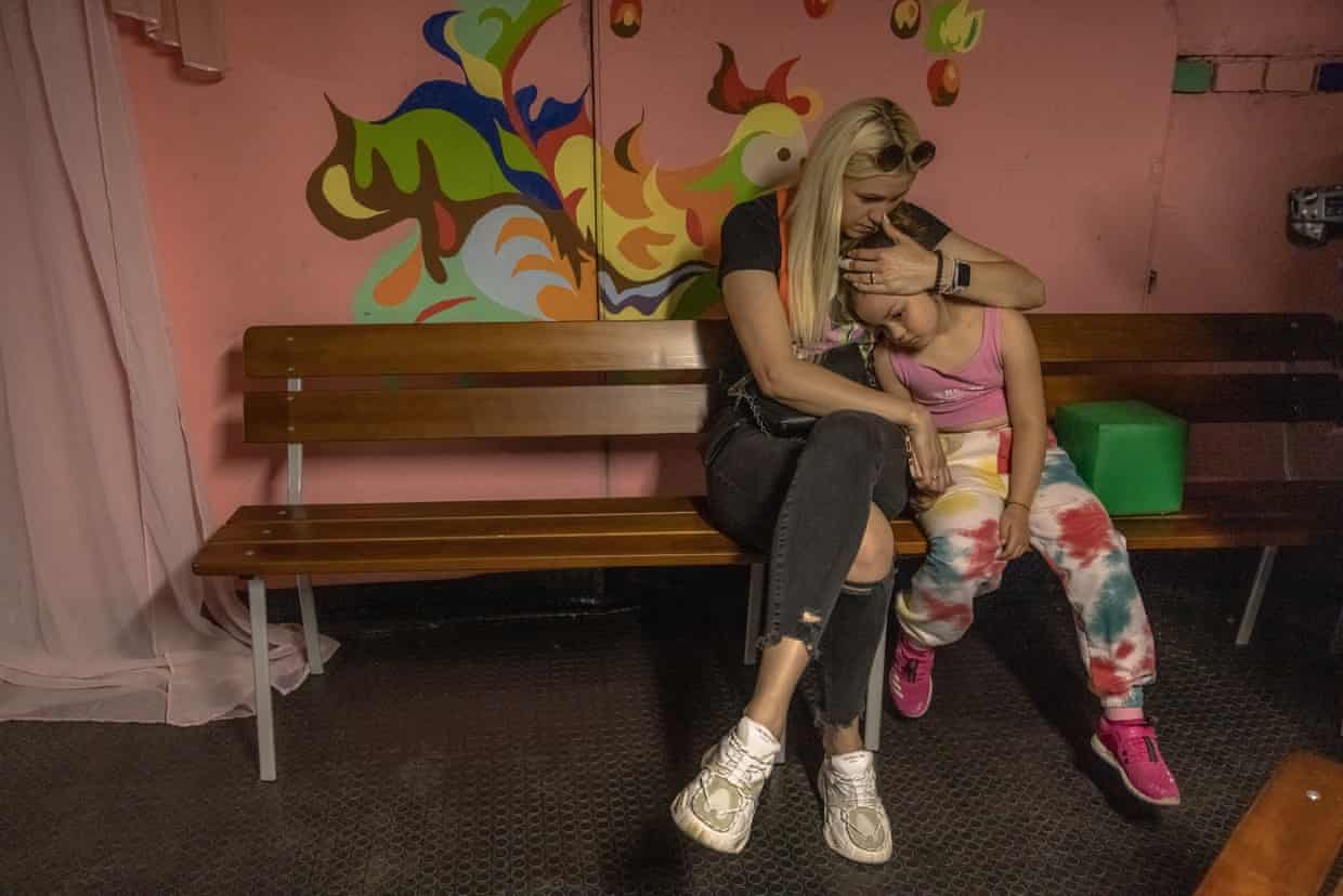 A woman sits with her daughter in a school’s shelter during an air raid alert in Kyiv, Ukraine