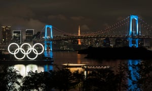 Illuminated Olympic rings are seen in front of the Rainbow Bridge