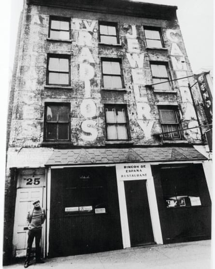 Man outside run-down building