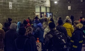 People wait in the nightly line to get into Brother Francis, the largest homeless shelter in Anchorage.