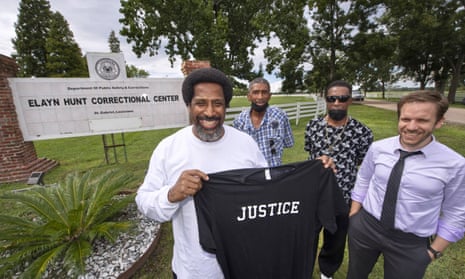 Sullivan Walter, 53, left, holds a shirt near Elayn Hunt Correctional Center in St Gabriel, Louisiana, with, left to right, his brothers Joseph Walter and Byron Walter Sr, and Innocence Project New Orleans legal director Richard Davis, just after his release on Thursday.