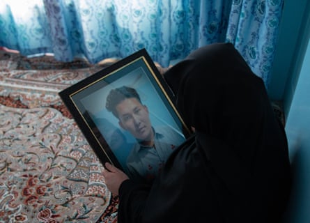 Amina holds a picture of her son, Ahmed Shah, who was beheaded among other coalminers in Mach, Balochistan.