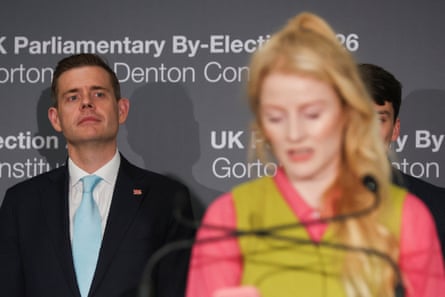 Reform UK candidate Matt Goodwin looks on as Hannah Spencer speaks.